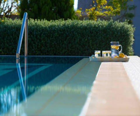Danae Villas Hersonissos Crete Blue Villa pool and a tray with drinks on poolside