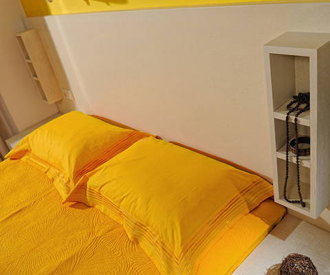 Danae Villas Hersonissos Crete Red Villa double bed with yellow sheets and decoration