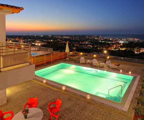 Danae Villas Hersonissos Crete Red Villa pool lit up at dusk