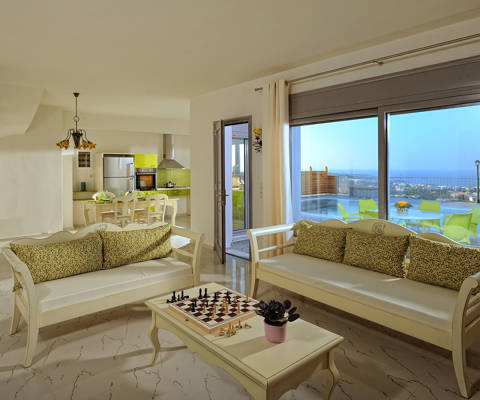 Danae Villas Hersonissos Crete Green Villa living room with a chess board on the table
