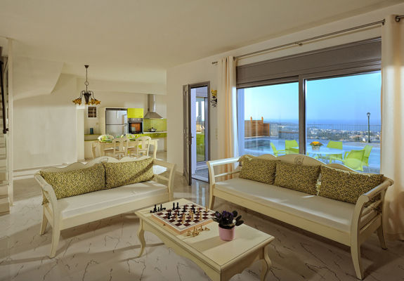 Danae Villas Hersonissos Crete Green Villa living room with a chess board on the table