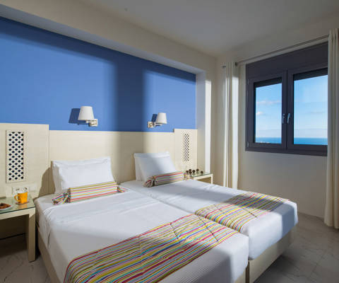 Danae Villas Hersonissos Crete Yellow Villa twin bedroom decorated beds
